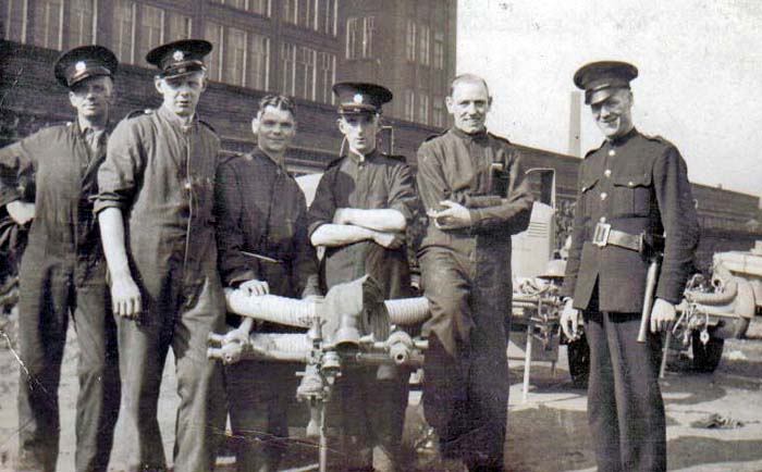 Members of the Auxiliary Fire Service in Farnworth during WW2. Billy Berry is centre with the hat and Arthur Stafford is to his left.