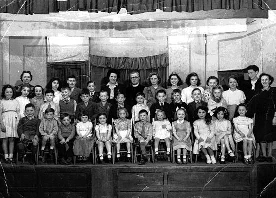 Children's Sunday School gathering onstage, circa 1947. The Rev E.J. Howells is pictured on the back row. Far left is Florrie Burrows and right are Elsie Moores and Nora Tootall.